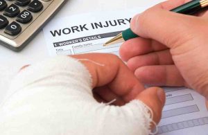 A man who would have benefited from workers compensation insurance filling out a workers comp application