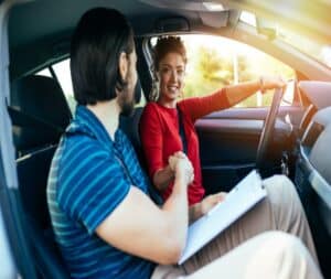 Teen Driving In Car with Driving School Instructor